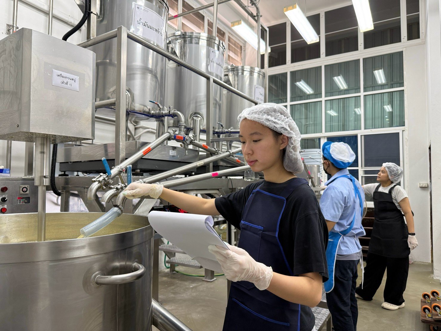 Winnie checking oil dosing into the soap mixing tank