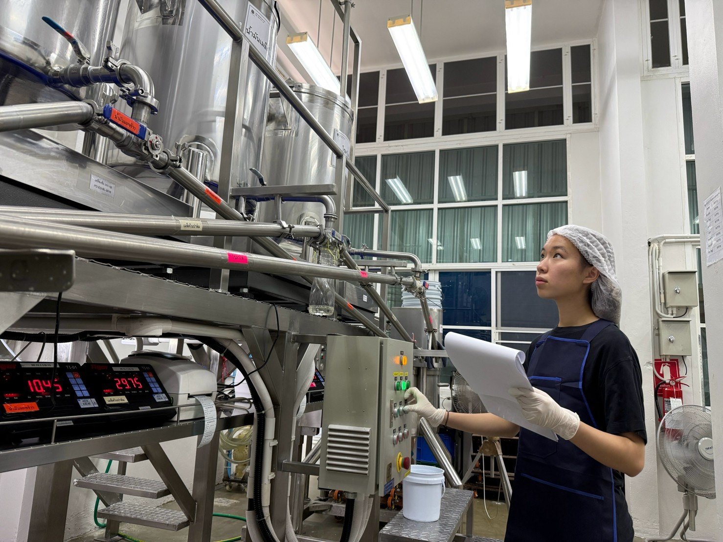 Winnie operating the soap production control panel